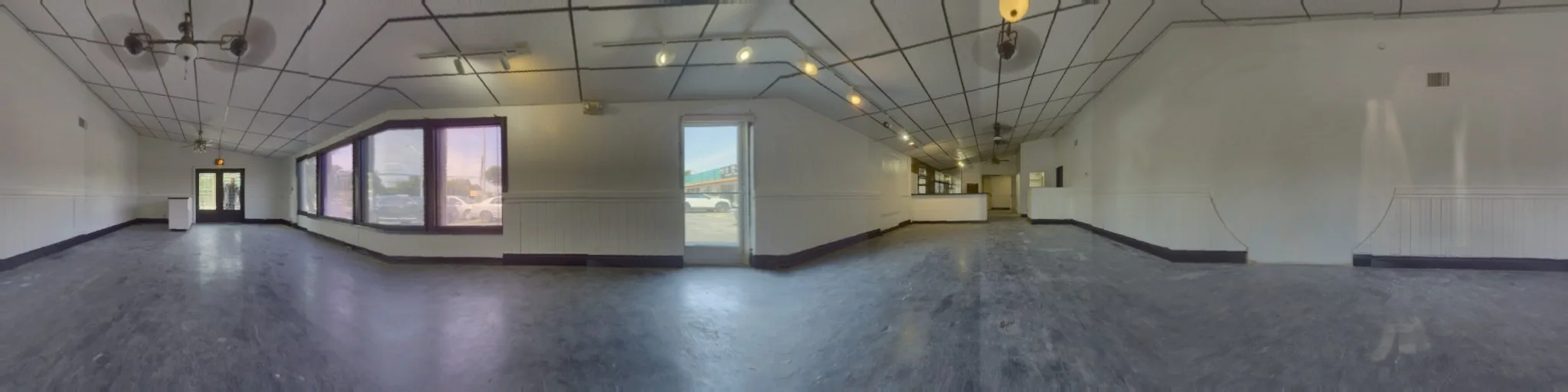 360-degree panorama of the empty front lobby, showing the drop ceiling, angled bay windows and the glass storefront door